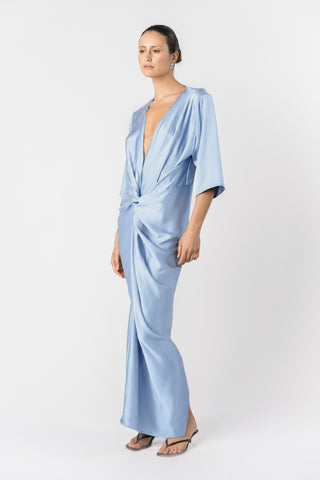 Model wearing the Signature Alex Kimono maxi dress in princess blue satin. sultry pose 