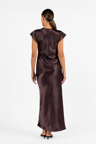 Back view of the One Fell Swoop Allure Draped Top in Aubergine, showing the smooth back, short sleeves and softly draped silhouette paired with a matching aubergine skirt.