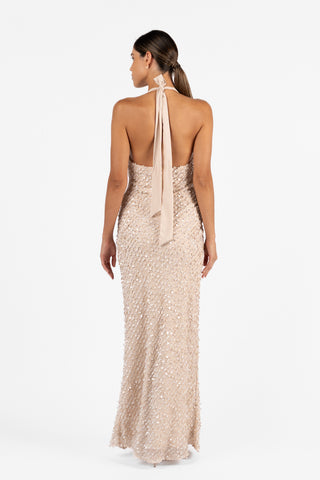 Back view of the Cloe Halter Maxi in Concha Sand, highlighting the open back, long halter ties and fitted embellished silhouette.
