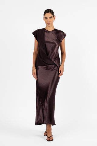 One Fell Swoop Allure Draped Top in Aubergine, featuring sculptural draping across the front, short cap sleeves and a fluid silhouette, styled with a matching aubergine skirt.