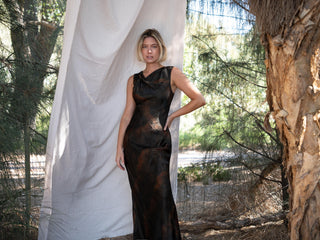 Model wearing the Francis Maxi Dress in Atomic Jacquard by One Fell Swoop featuring a draped neckline and fitted floor length silhouette.