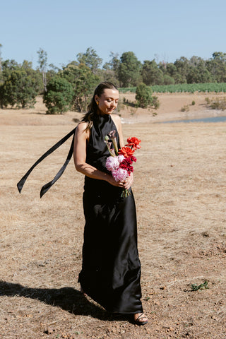 One Fell Swoop Kristina Dress in Obsidian featuring a draped cowl halter neckline and open back, halter maxi dress.