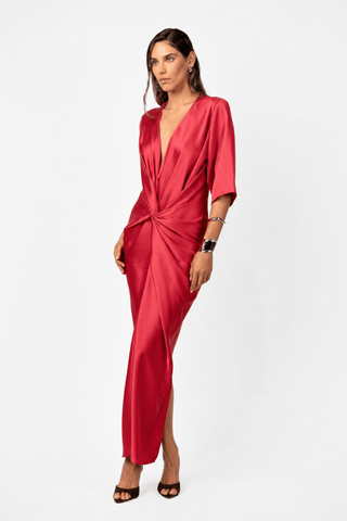 Side view of the Alex Kimono Maxi in Venetian Red by One Fell Swoop. Sculptural satin dress featuring kimono sleeves, a deep V neckline, signature front twist and fluid maxi skirt.