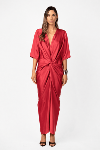 Alex Kimono Maxi in Venetian Red by One Fell Swoop. Fluid satin maxi dress with a plunging V neckline, relaxed kimono sleeves and signature sculptural twist detail at the waist.