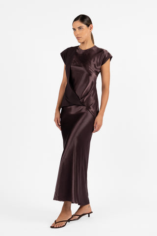 Side view of the One Fell Swoop Allure Draped Top in Aubergine, highlighting the layered draping across the bodice and elegant fluid shape of the matching two-piece look.