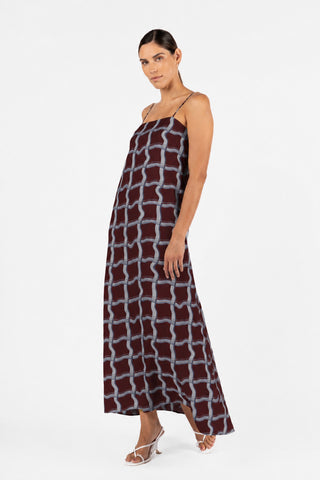 Side movement view of the One Fell Swoop Duplicity Slip in the exclusive Vesna print, showcasing the flowing bias-cut maxi silhouette.