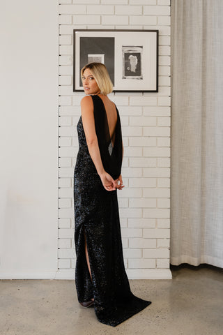 Velare Maxi in Silhouette Black Sequin angled back view showing draped chiffon overlay detail
