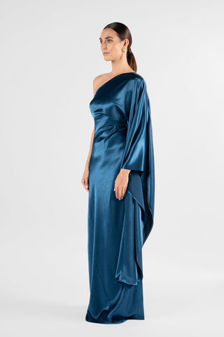 One Fell Swoop Arc Maxi in Caspian, side view showing the sleeve falling alongside the body into a floor length skirt, blue satin gown.