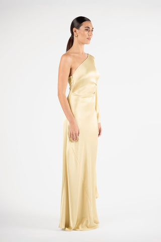One Fell Swoop Arc Maxi in Dune, side profile of the one shoulder neckline and gathered waist, pale gold satin maxi gown.