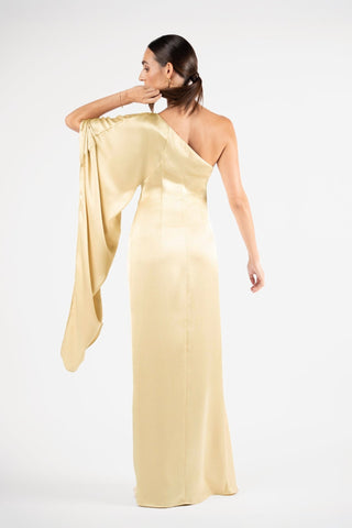 One Fell Swoop Arc Maxi in Dune, back three-quarter view with the wide sleeve lifted to show its volume, pale gold satin gown.
