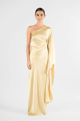 One Fell Swoop Arc Maxi in Dune, front view of the one shoulder neckline and cascading single sleeve, pale gold satin maxi gown.