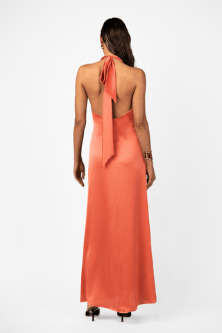  Back view of the One Fell Swoop Caira Gown in Clay featuring an open back, self-tie halter detail and flowing liquid satin maxi gown. 