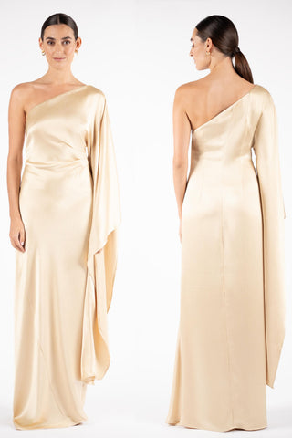 One Fell Swoop Arc Maxi in Dune featuring an asymmetric one shoulder neckline and cascading single sleeve, pale gold satin maxi gown.
