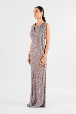One Fell Swoop Glinch Gown in Ink Veil, side three-quarter view showing the cowl neckline, the sleeveless armhole and the sheer chiffon panel falling from the shoulder down the front of the fitted bodice into a long, close-fitting skirt with a printed grey and rust-red lattice.