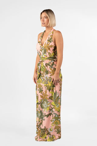 One Fell Swoop Helix Halter in Jardin de Soie, side three-quarter view showing the halter V neckline, bare shoulders and arms, the gathered twist at the waist and the long fluid skirt in the pink baroque botanical print.
