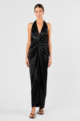 One Fell Swoop Talia Dress in Obsidian - front view of black satin halter neck maxi dress with deep V neckline and sculptural twist knot waist detail