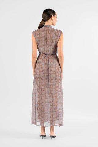 One Fell Swoop Linea Wrap Maxi in Ink Veil, back view of the sheer chiffon wrap maxi, showing the high rounded back neckline, short cap sleeves, the waist tie at the back and the long, straight skirt falling to the ankle in a grey and rust-red brushstroke check print.