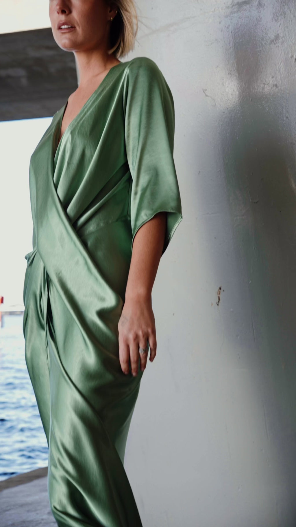 Video of the One Fell Swoop Portishead Robe in sage green satin highlighting the fabric drape and silhouette.