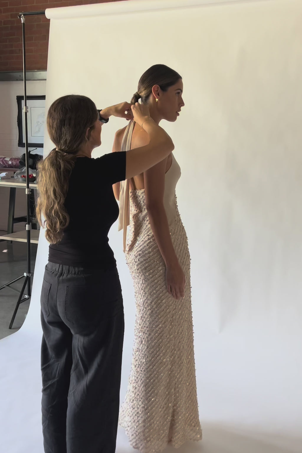 A video showing the Cloe Halter Maxi in Concha Sand, featuring a plunging halter neckline, fitted silhouette and embellished sequin maxi skirt.