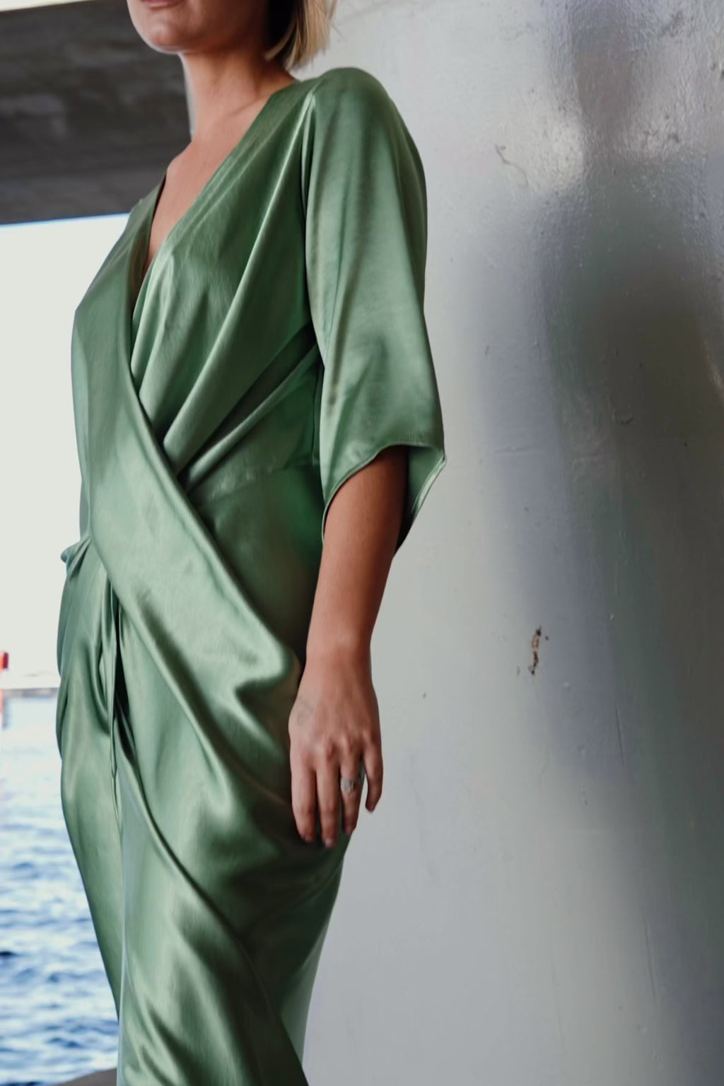 Video of the One Fell Swoop Portishead Robe in sage green satin highlighting the fabric drape and silhouette.
